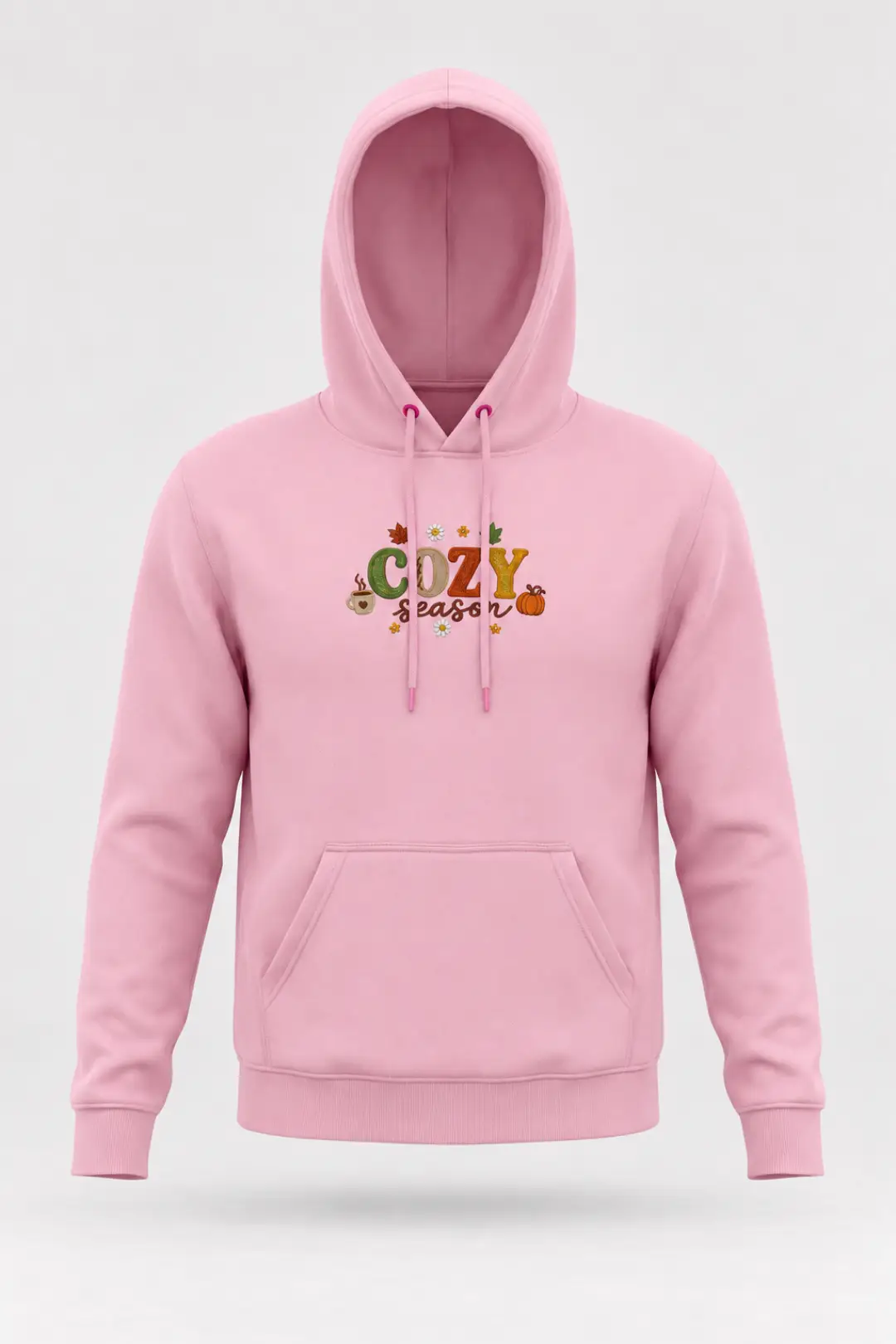 Pink custom embroidered hoodie with “COZY season” lettering, pumpkin, coffee mug and daisy embroidery on the chest, drawstring hood and front pocket