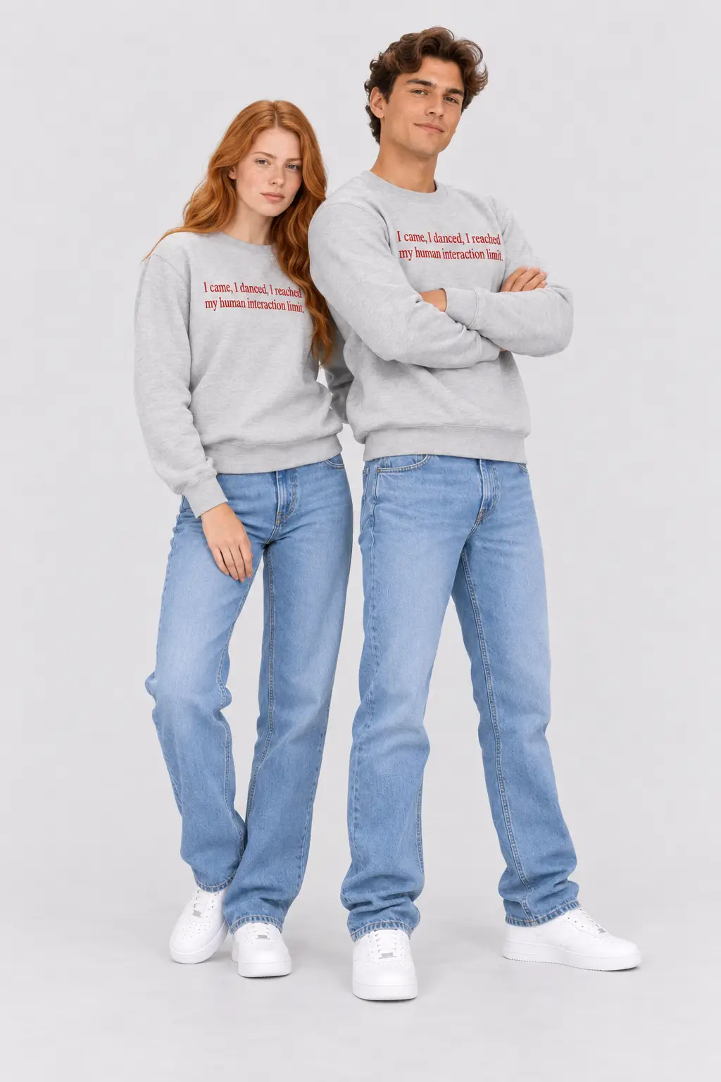 Custom embroidered unisex grey sweatshirts for men and women featuring red text, styled with blue jeans and white sneakers.